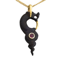 Ebony gold and ruby serpent pendant