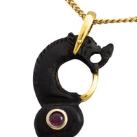 Ebony gold and ruby serpent pendant