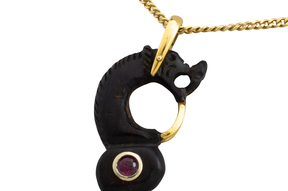 Ebony gold and ruby serpent pendant