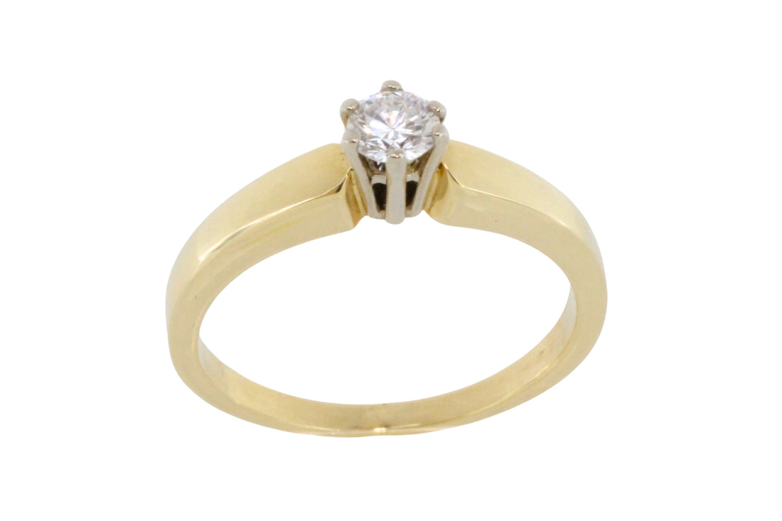 Diamond solitaire ring in yellow and white gold