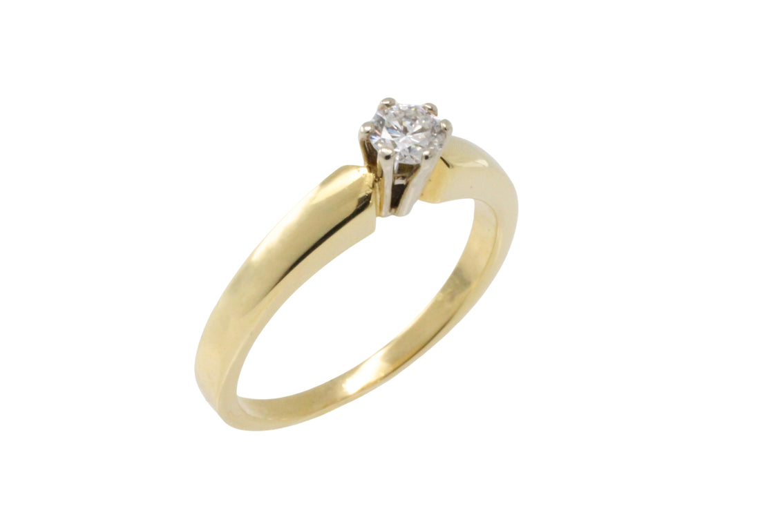 Diamond solitaire ring in yellow and white gold