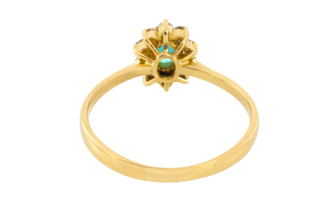 Emerald and diamond cluster ring in 18 carat gold