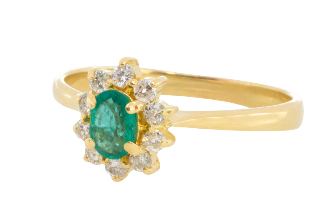Emerald and diamond cluster ring in 18 carat gold