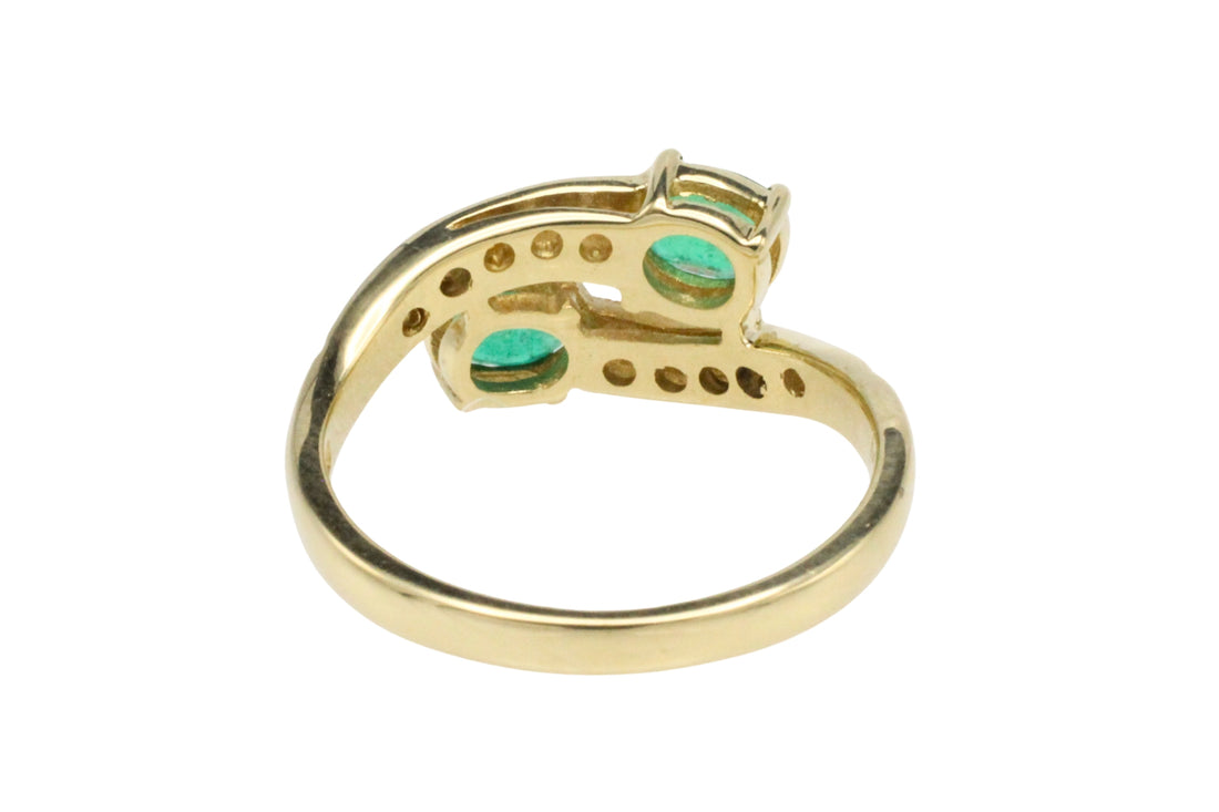 Vintage emerald and diamond crossover ring